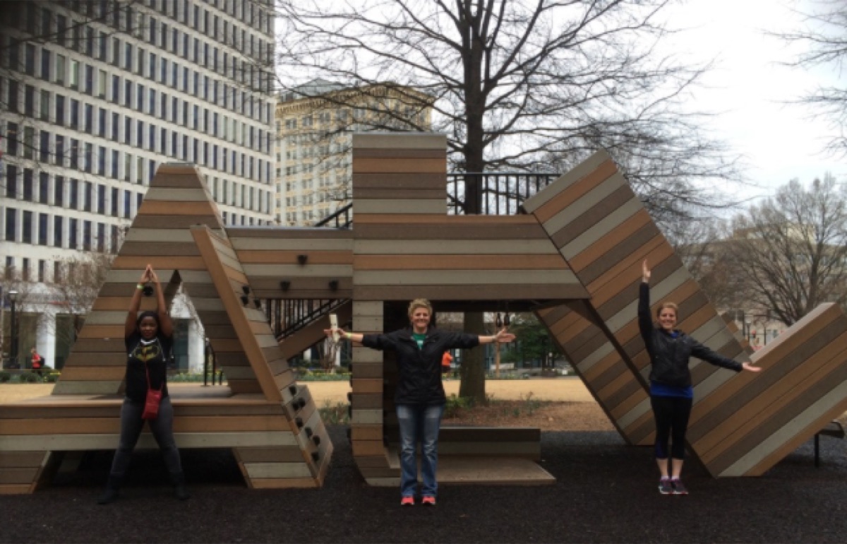 Group exploring an Atlanta park sculpture