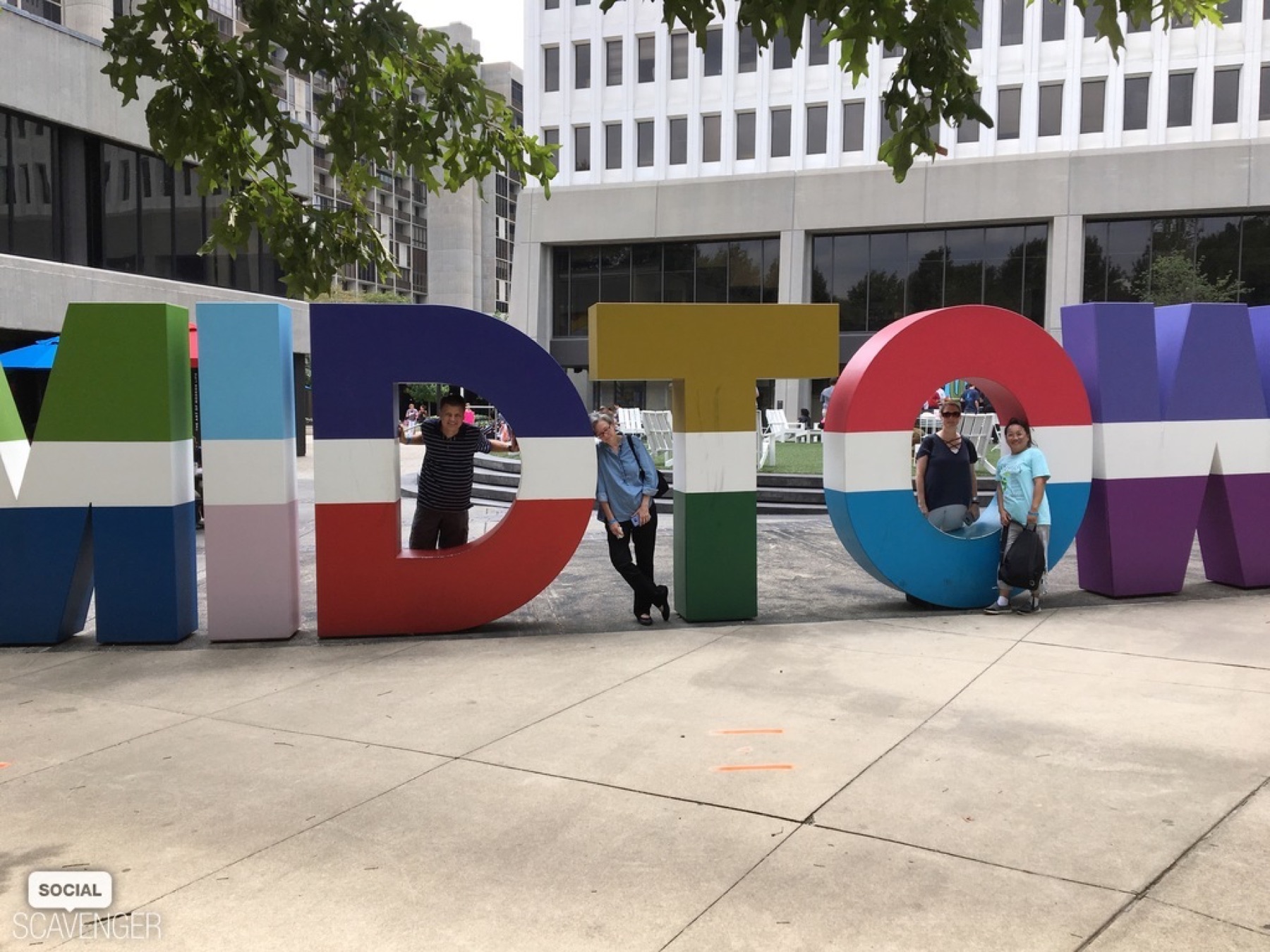 Group posing in the colorful Midtown Atlanta letters